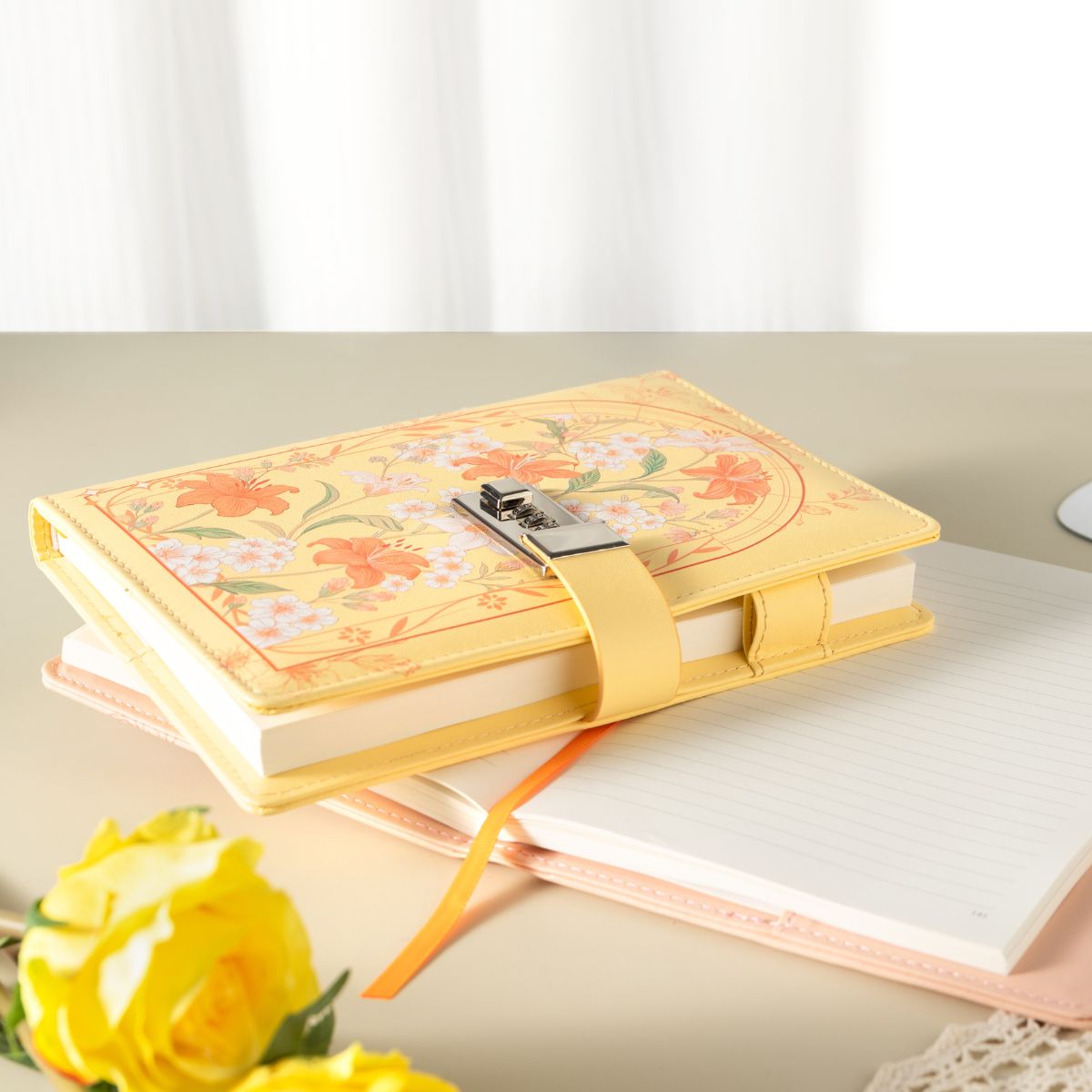 `A5 yellow floral vegan leather lockable journal with metal clasp, styled with yellow roses`