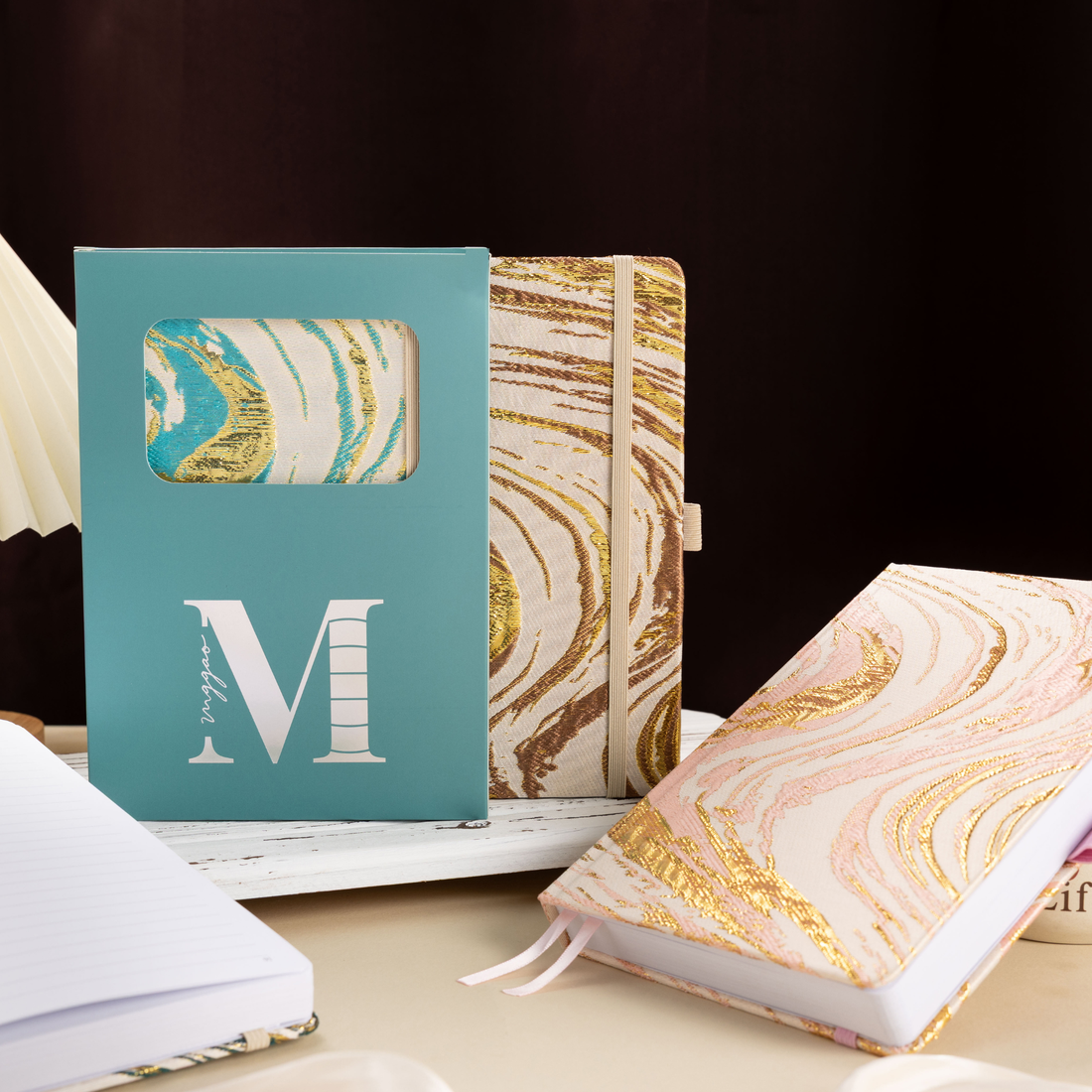 A5 premium fabric notebook placed next to its signature light blue window-cut gift box, ready for gifting to writers and students.