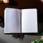 Open A5 lined notebook showing clean white pages with Date and Memo No. headers, a pink ribbon bookmark, and a black elastic closure.