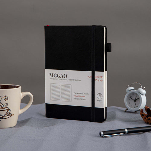 A5 Black Vegan Leather Notebook by MGGAO on Desk, 188 Pages Hardcover Journal with Elastic Closure