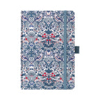 A5 blue ornamental floral fabric notebook standing upright on a white background with a matching blue elastic closure, featuring an intricate symmetrical botanical pattern with red and white accents.