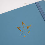 A5 Blue Vegan Leather Hummingbird Notebook Close-up, Gold Foil Hummingbird Emboss with Dried Flowers