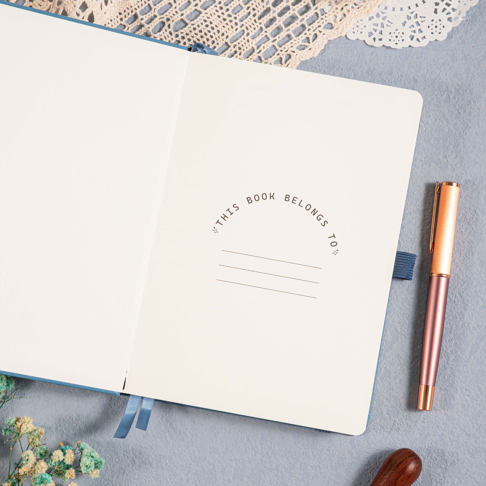 A5 Blue Vegan Leather Hummingbird Notebook, Personal Information Page with Pen on Desk