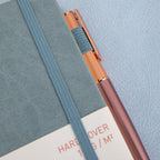 MGGAO A5 Grey Vegan Leather Notebook Close-up, Pen and Packaging Sleeve Detail