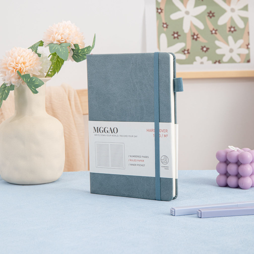 MGGAO A5 Grey Vegan Leather Notebook Standing on Desk, Hardcover Journal with Elastic Closure