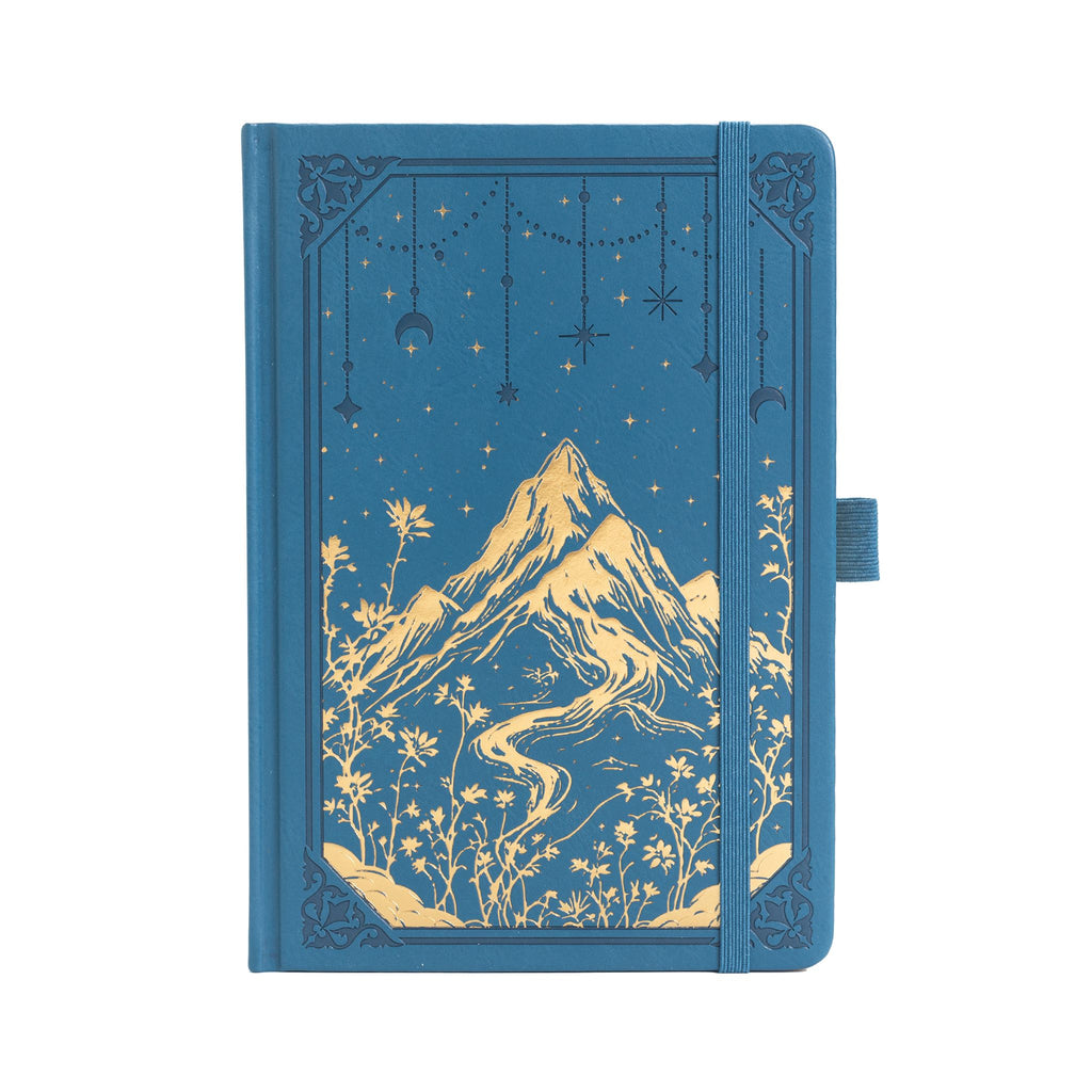 A5 deep blue vegan leather notebook with gold foil mountain and starry night embossing, standing upright on a white background with a matching blue elastic band.