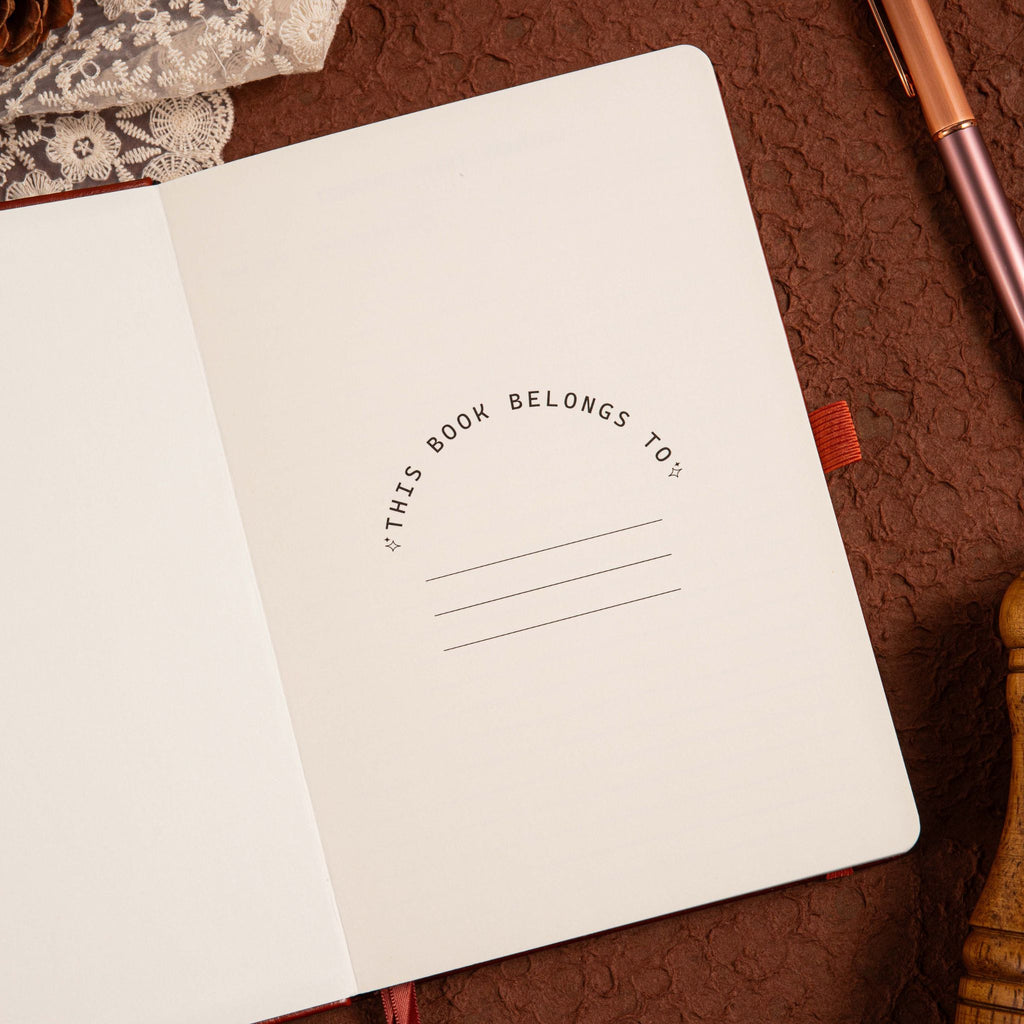 A5 Brown Vegan Leather Hummingbird Notebook, Personal Information Page with Pen on Desk