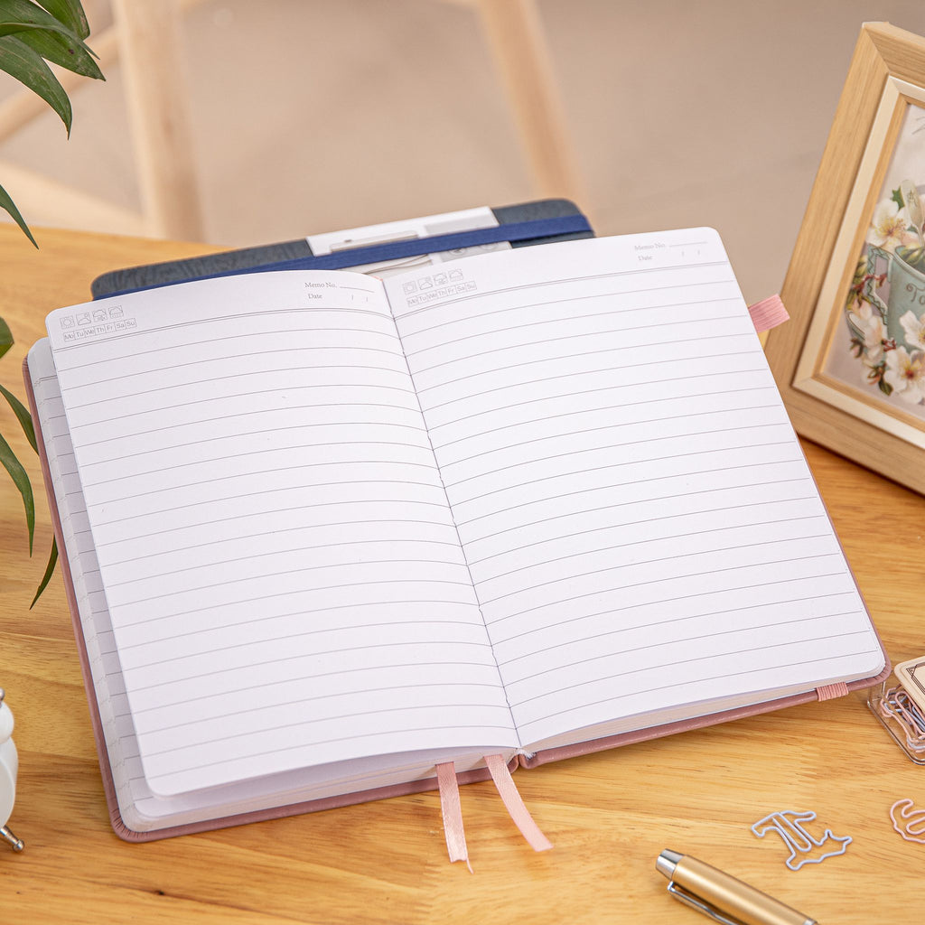 MGGAO A5 Couple Pink Vegan Leather Hummingbird Notebook Open, Numbered Pages with Date Headers and 9mm Ruled Lines on Wooden Desk