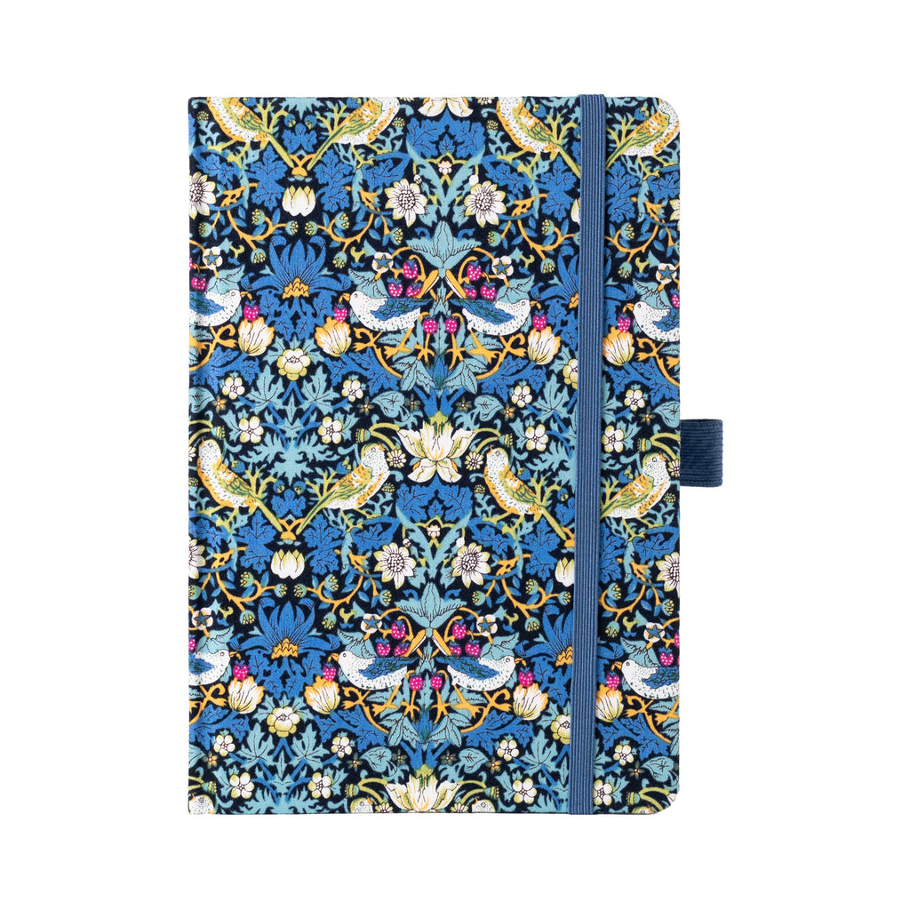 A5 blue bird and botanical fabric notebook standing upright on a white background, featuring an intricate symmetrical pattern of birds, flowers, and vines, finished with a matching blue elastic closure.