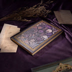 A5 Dark Purple Taupe Floral Tapestry Hardcover Notebook Flat Lay on Purple Silk, Gold Gilded Edges with Vintage Letters and Dried Flowers