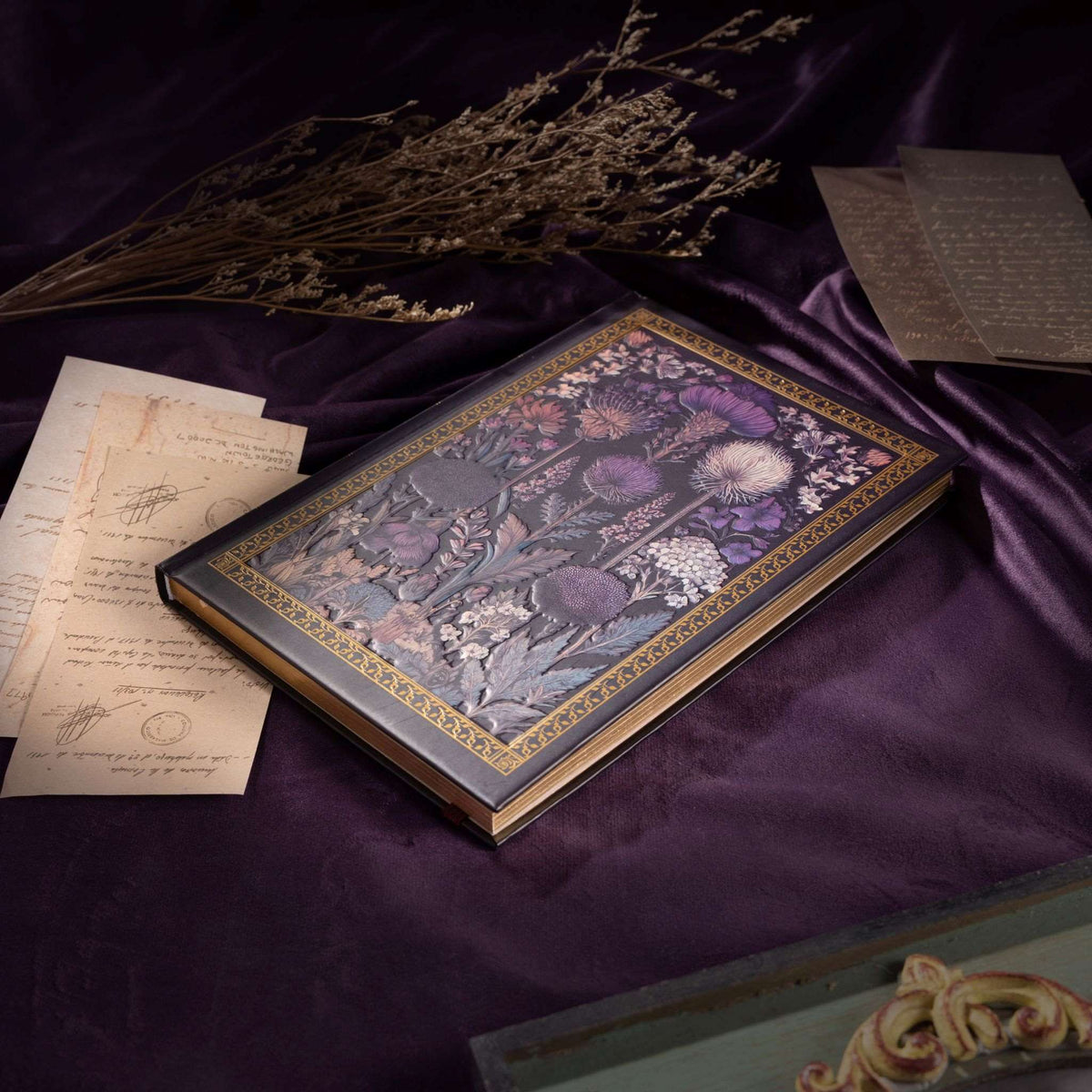 A5 Dark Purple Taupe Floral Tapestry Hardcover Notebook Flat Lay on Purple Silk, Gold Gilded Edges with Vintage Letters and Dried Flowers