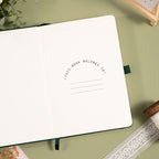 A5 Green Vegan Leather Hummingbird Notebook, Personal Information Page with Pen on Desk