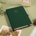 A5 Green Vegan Leather Hummingbird Notebook on Desk with Dried Flowers and Pen