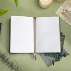 Close-up of the open A5 notebook showing the 100gsm lined paper interior with elegant gold borders and corner numbers.