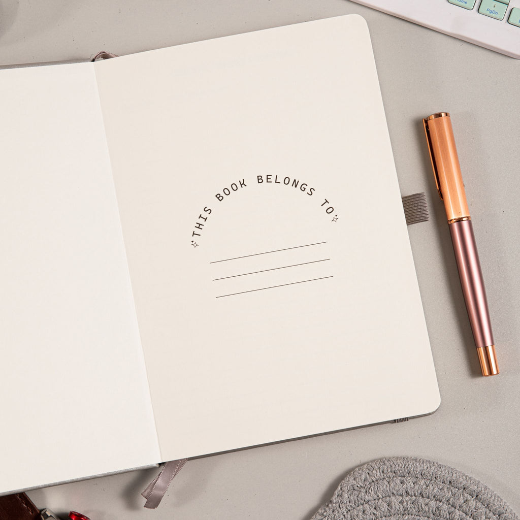 A5 Grey Vegan Leather Hummingbird Notebook, Personal Information Page with Pen on Desk