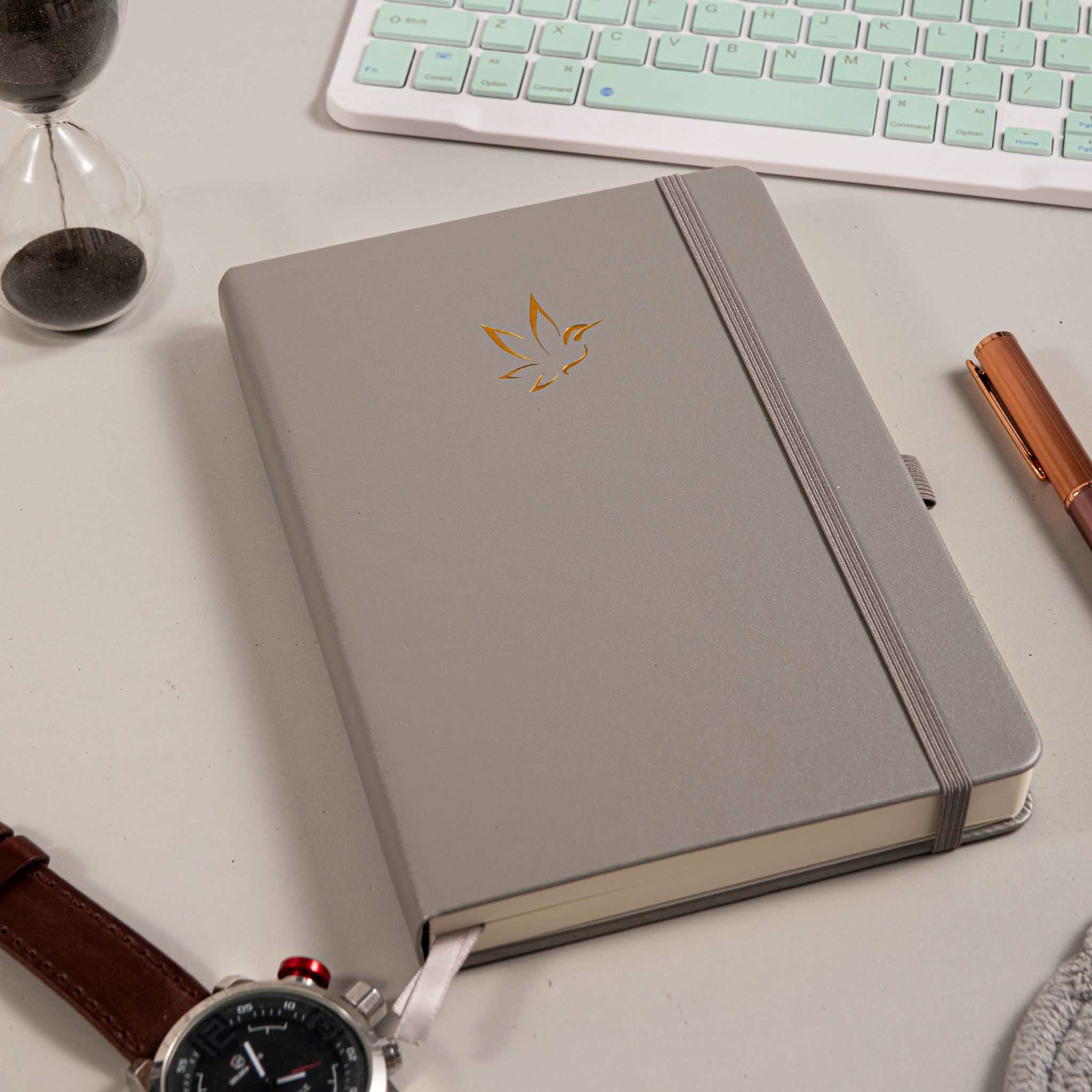 A5 Grey Vegan Leather Hummingbird Notebook on Desk, Gold Foil Cover with Pen and Watch