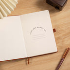 A5 Red Vegan Leather Hummingbird Notebook, Personal Information Page with Pen on Desk