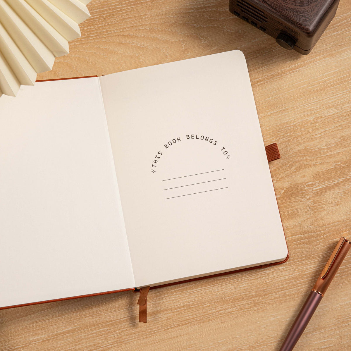 A5 Red Vegan Leather Hummingbird Notebook, Personal Information Page with Pen on Desk
