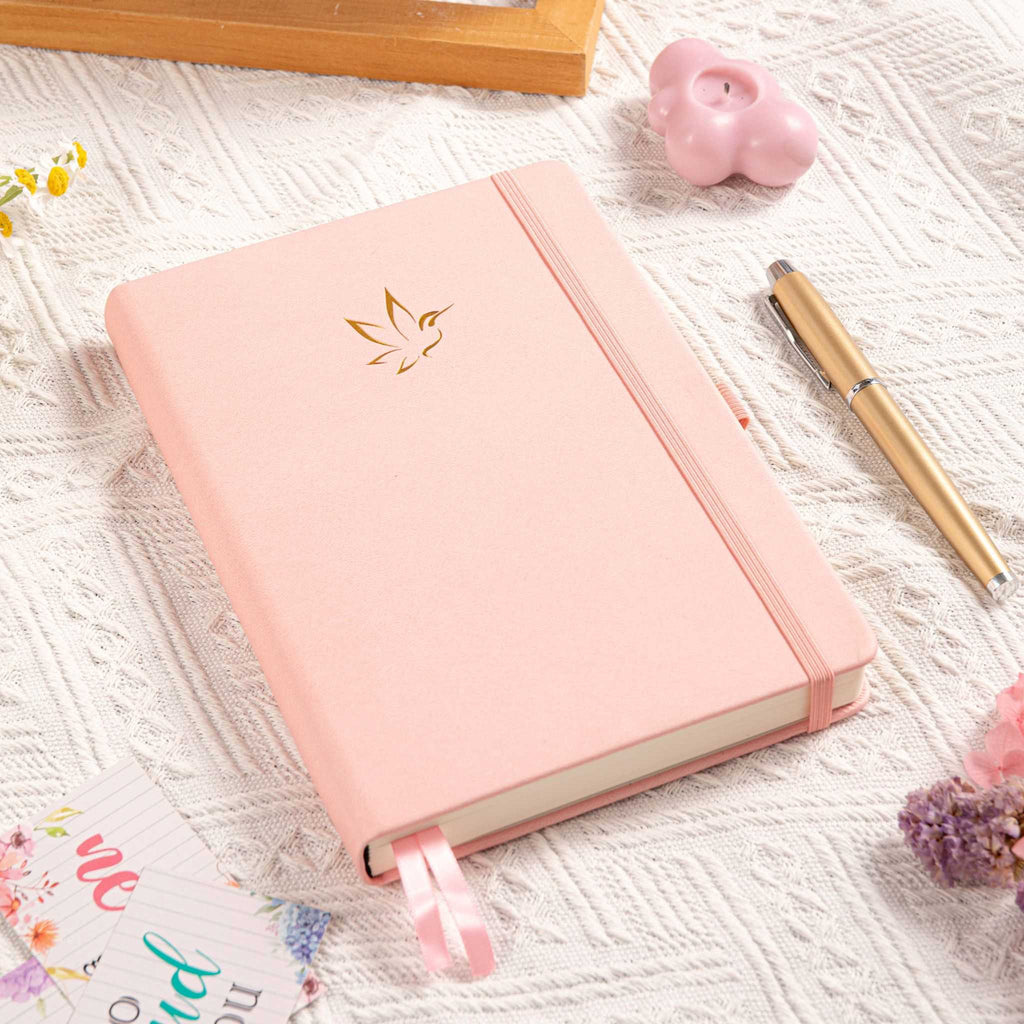 A5 Pink Vegan Leather Hummingbird Notebook on Desk with Dried Flowers and Pen