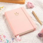 A5 Pink Vegan Leather Hummingbird Notebook on Desk with Dried Flowers and Pen