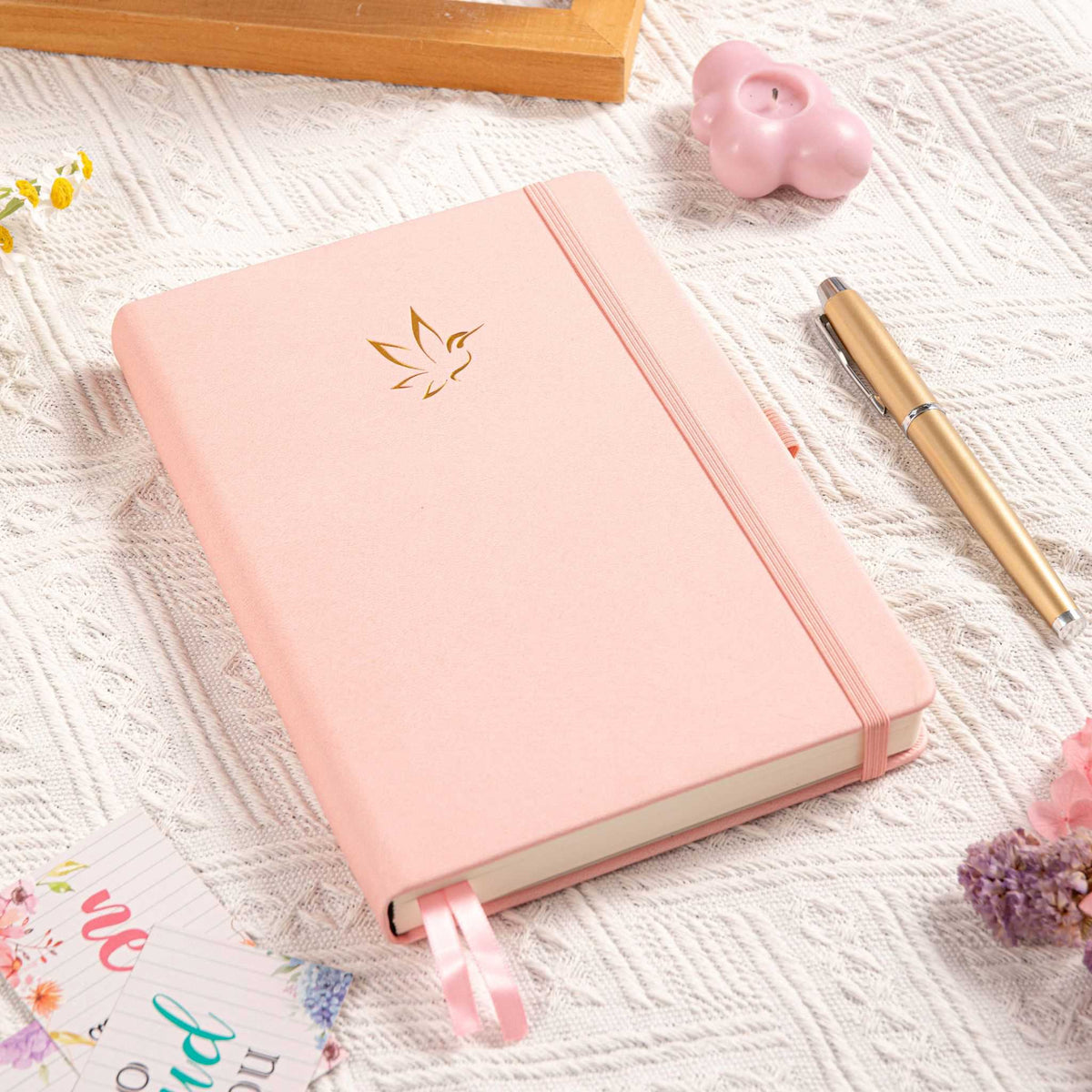 A5 Pink Vegan Leather Hummingbird Notebook on Desk with Dried Flowers and Pen