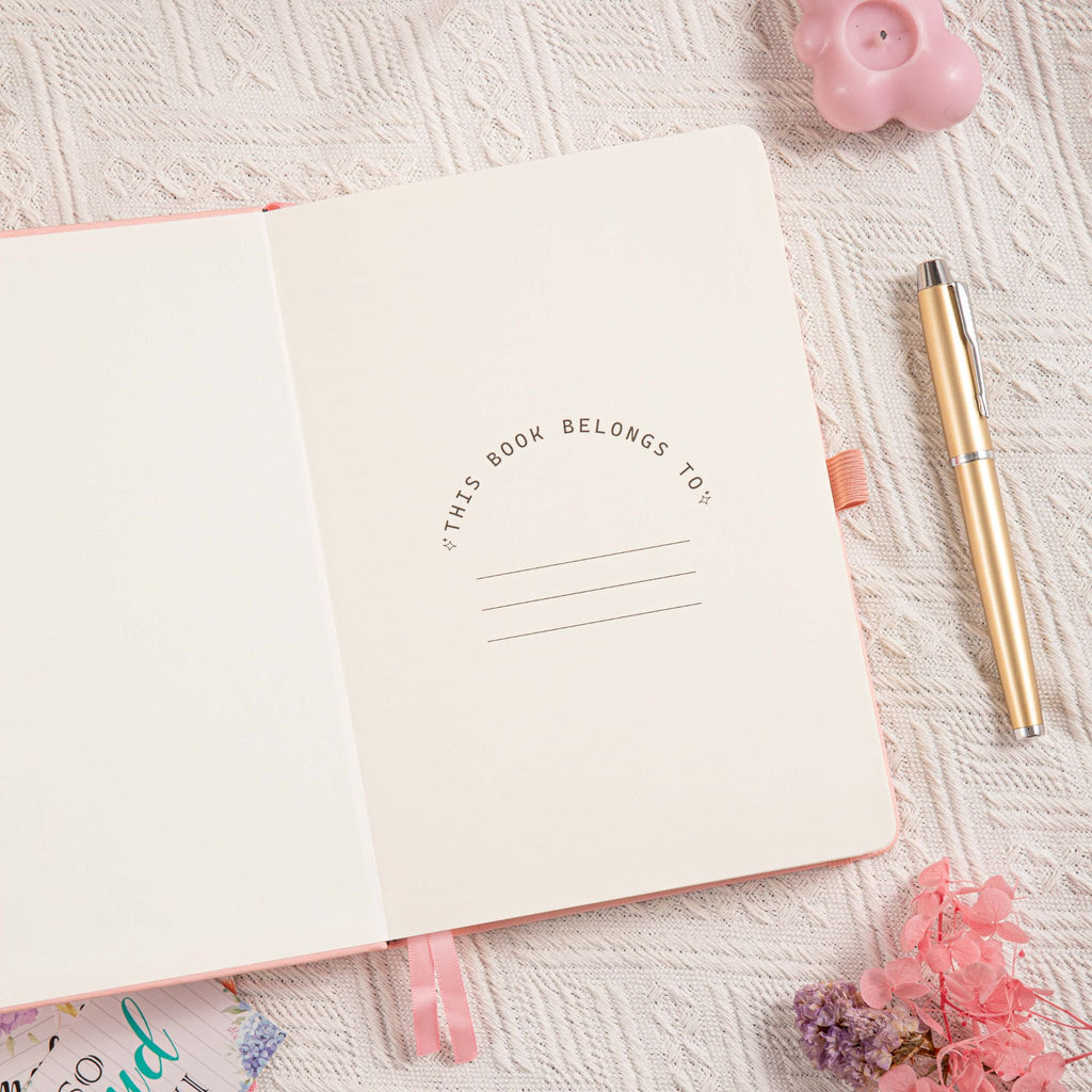 A5 Pink Vegan Leather Hummingbird Notebook, Personal Information Page with Pen on Desk