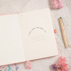 A5 Pink Vegan Leather Hummingbird Notebook, Personal Information Page with Pen on Desk