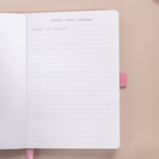 Close-up of the content index page of the pink ditsy floral notebook, showing "CONTENT / INHALT / CONTENU" headers and lined topic sections.