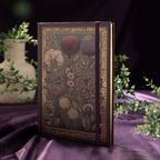 A5 Purple Taupe Floral Tapestry Hardcover Notebook Standing on Purple Silk, Elastic Closure with Green Plants Background