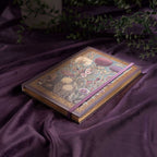 A5 Purple Taupe Floral Tapestry Hardcover Notebook Flat Lay on Purple Silk, Gold Gilded Edges with Plants Background