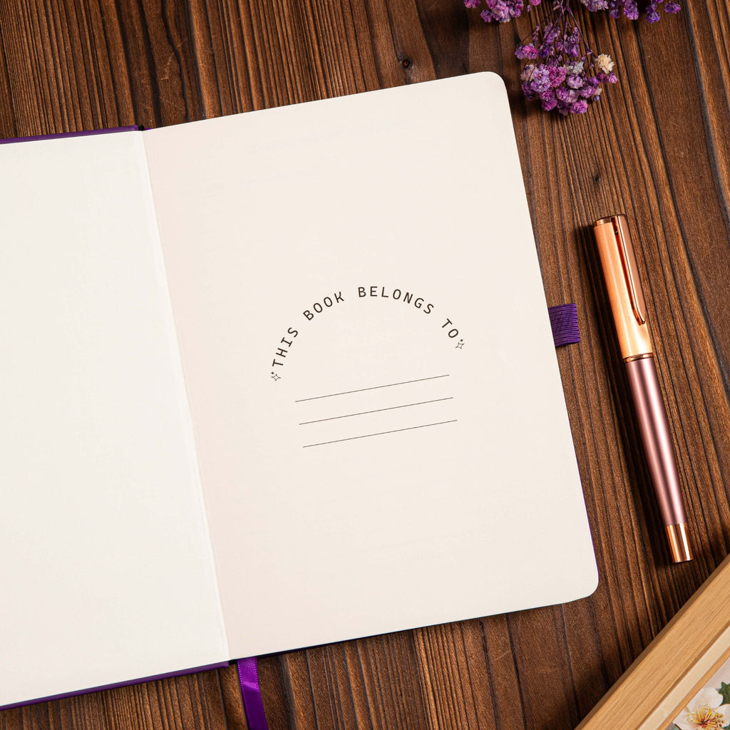 A5 Purple Vegan Leather Hummingbird Notebook, Personal Information Page with Pen on Desk