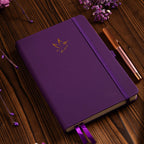 A5 Purple Vegan Leather Hummingbird Notebook on Desk with Wooden Pen and Dried Flowers