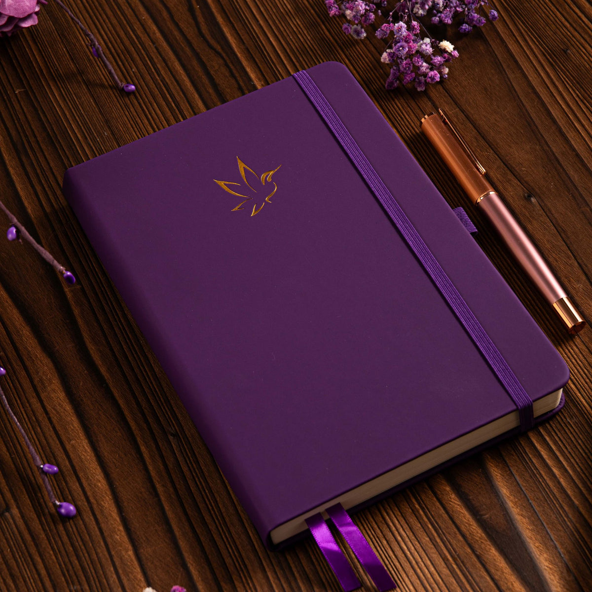 A5 Purple Vegan Leather Hummingbird Notebook on Desk with Wooden Pen and Dried Flowers