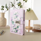 Purple floral vegan leather journal with a metal password lock, standing upright on a light beige desk with a lamp and plant.