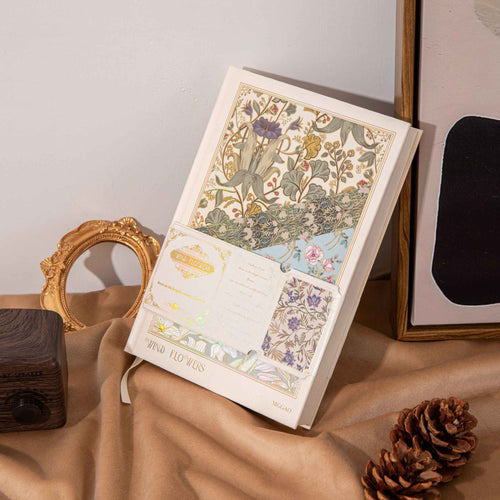A5 Wind Flowers Hardcover Lined Notebook with Belly Band on Wooden Desk, Vintage Gold Frame and Pinecones