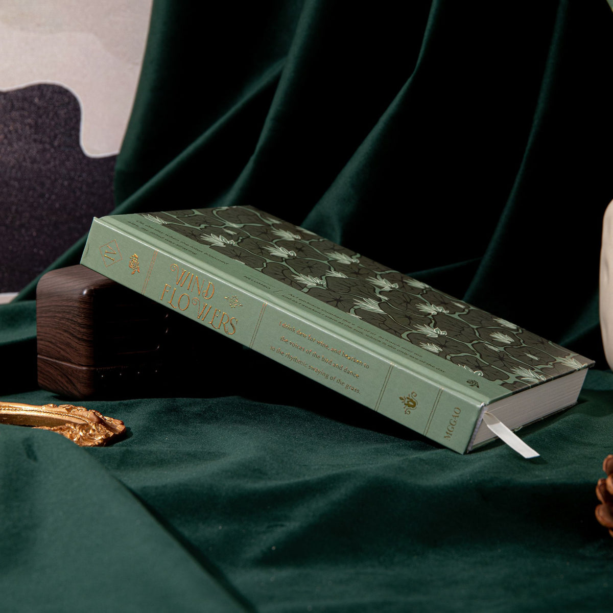 A5 Wind Flowers Hardcover Lined Notebook Side View on Dark Green Silk, Gold Foil Cover and Belly Band