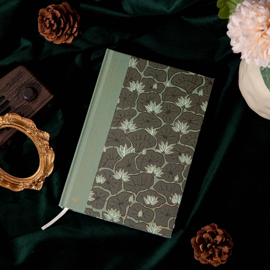 A5 Wind Flowers Hardcover Lined Notebook Side View on Dark Green Silk, Gold Foil Spine and Water Lily Cover Detail