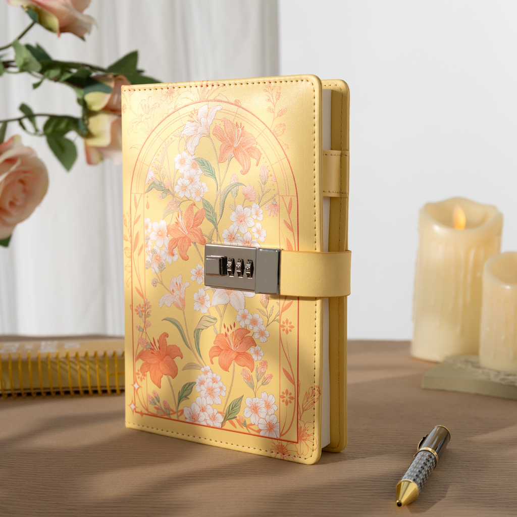 A5 yellow floral vegan leather notebook standing upright on a light wooden desk, featuring a metal combination lock, yellow elastic band, and styled with a candle and flowers.