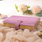 B6 Purple Rose Embossed Vegan Leather Journal with Gold Heart Lock and Gilded Edges, Lying on Fluffy Background