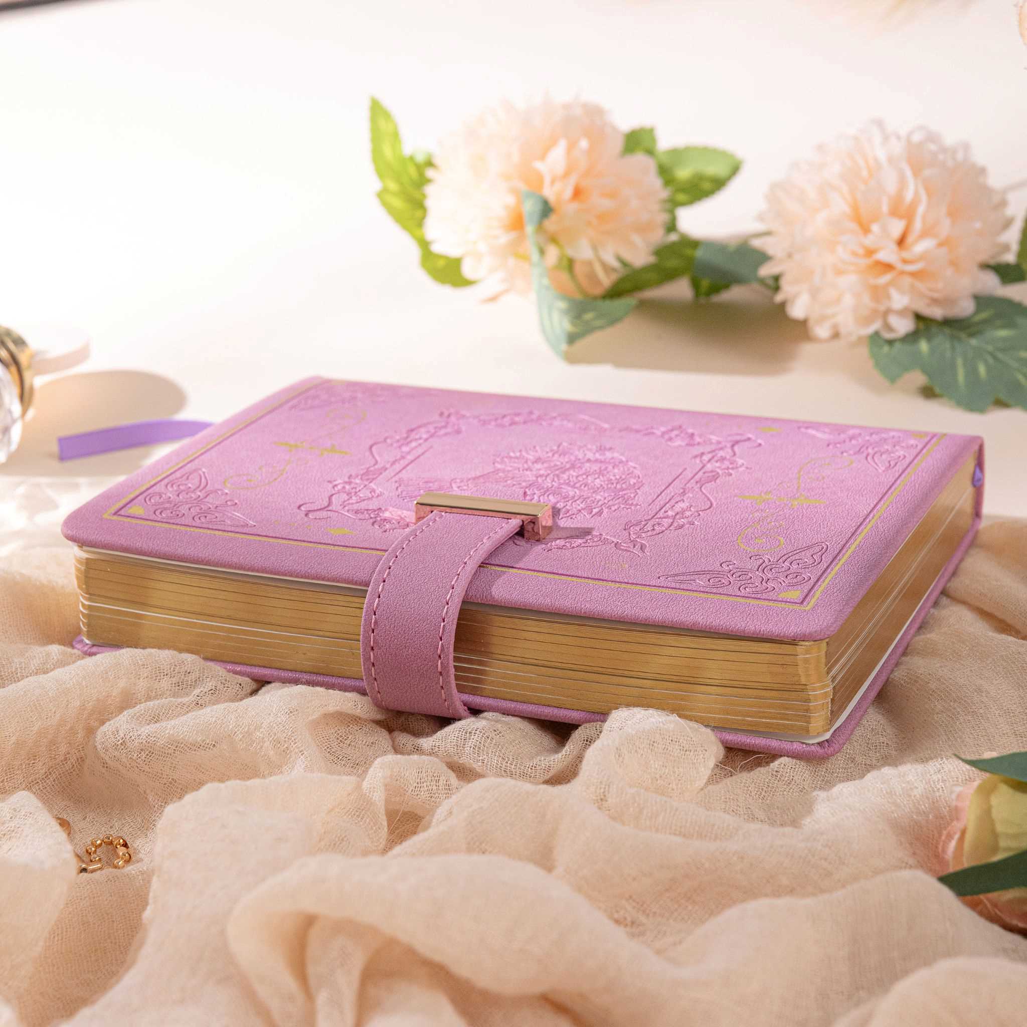B6 Purple Rose Embossed Vegan Leather Journal with Gold Heart Lock and Gilded Edges, Lying on Fluffy Background