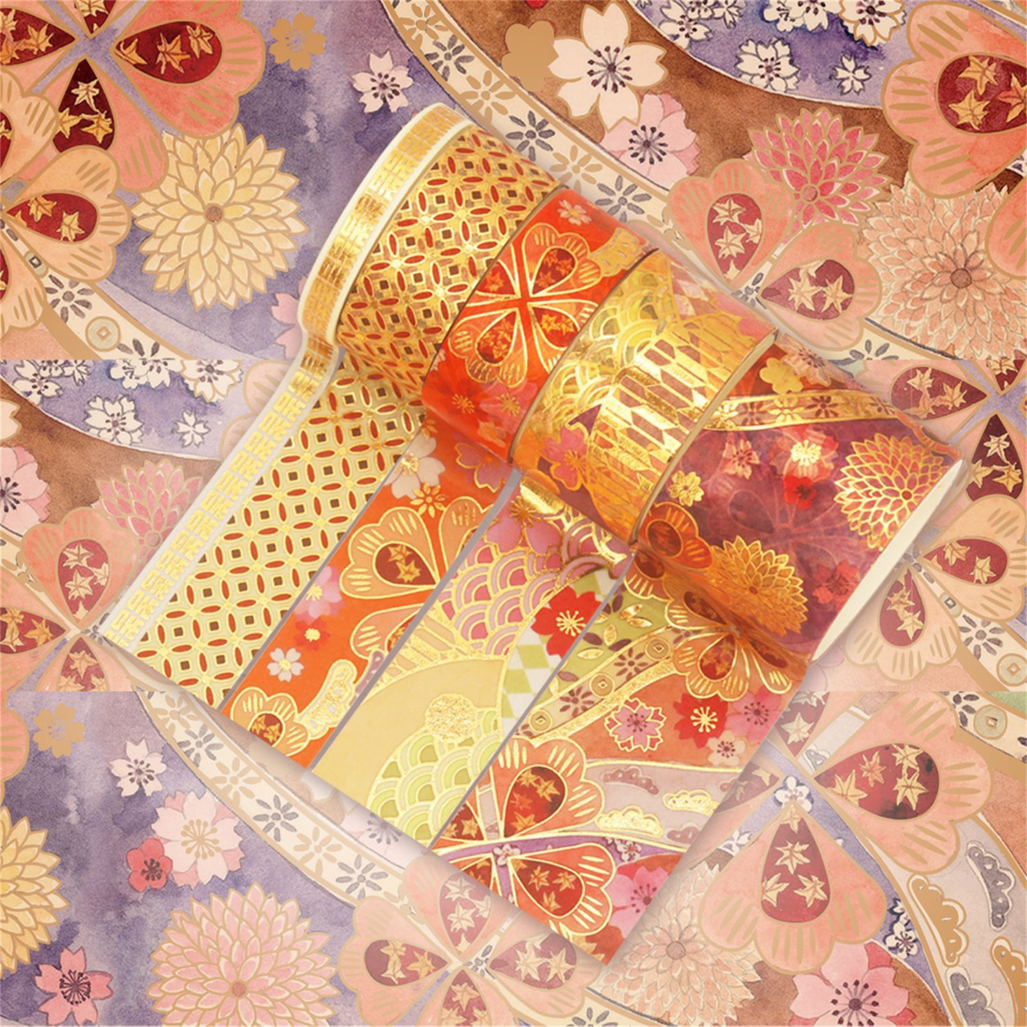 Orange, red, and purple blossom washi tapes partially unrolled on a warm floral background, showcasing intricate gold foil geometric lattice, fan-shaped floral patterns, and colorful floral motifs.