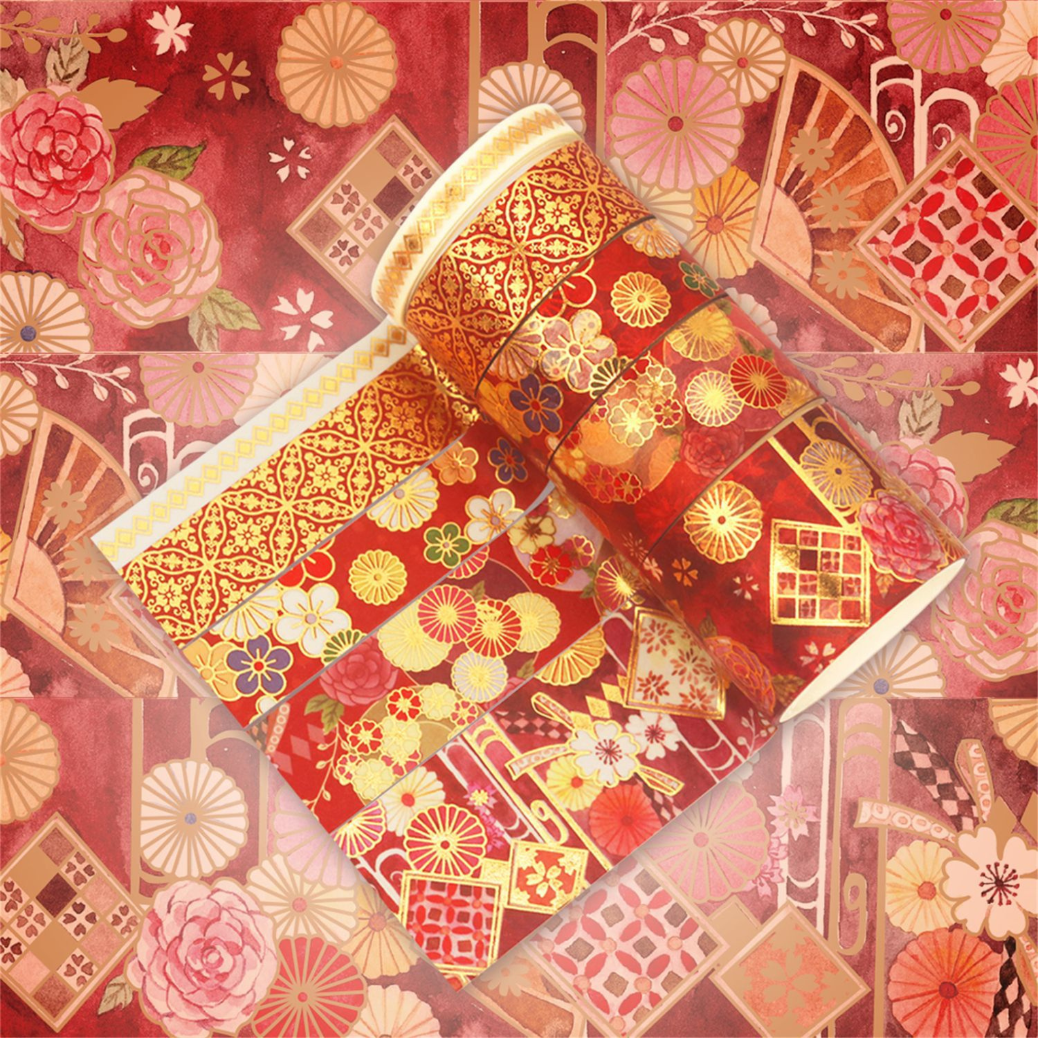 Close-up of the red and gold blossom washi tape design, featuring watercolor pink roses, stylized florals, gold geometric lattice accents, and a peek of the gold foil tape edge.