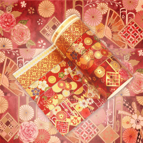Close-up of the red and gold blossom washi tape design, featuring watercolor pink roses, stylized florals, gold geometric lattice accents, and a peek of the gold foil tape edge.