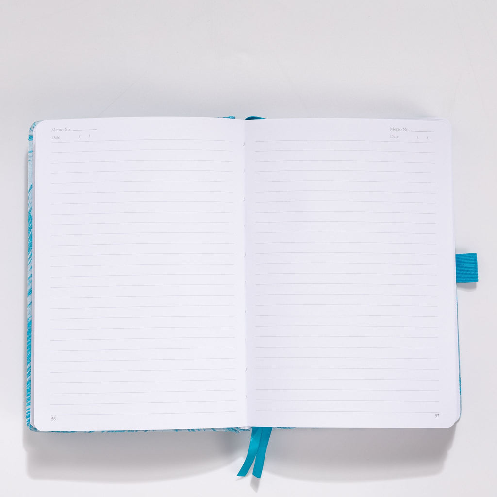 Open A5 notebook showing the lined paper interior with light blue ribbon bookmark