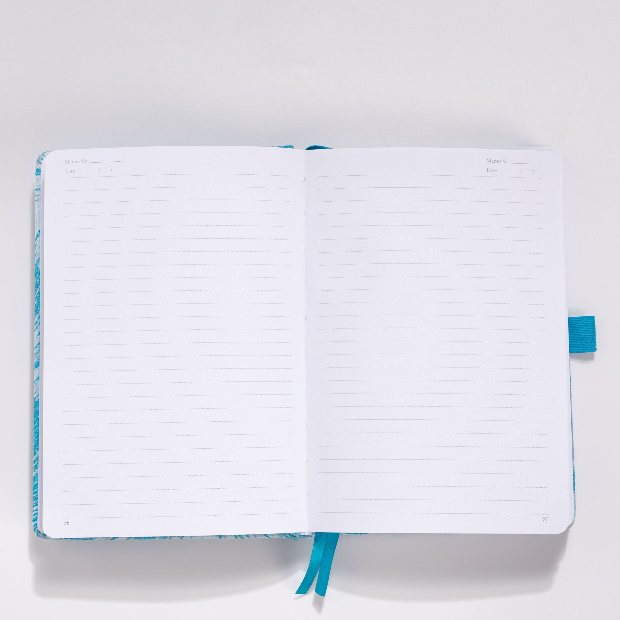 Open A5 notebook showing the lined paper interior with light blue ribbon bookmark