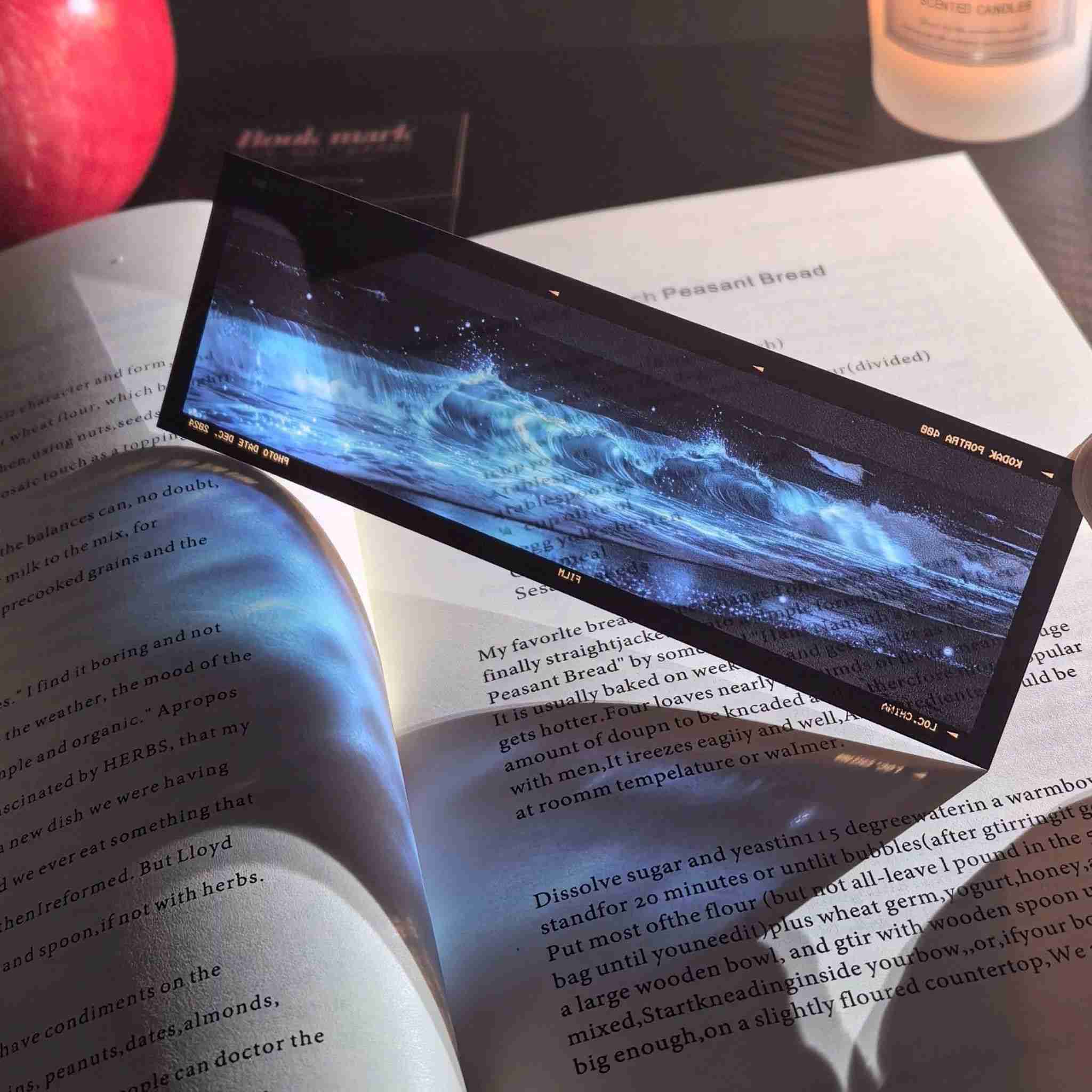 Film frame acrylic bookmark – glowing blue bioluminescent waves