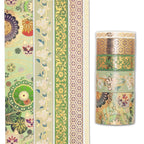 
Green gold foil washi tape rolls with intricate floral designs, partially unrolled to display the continuous pattern and metallic shine.