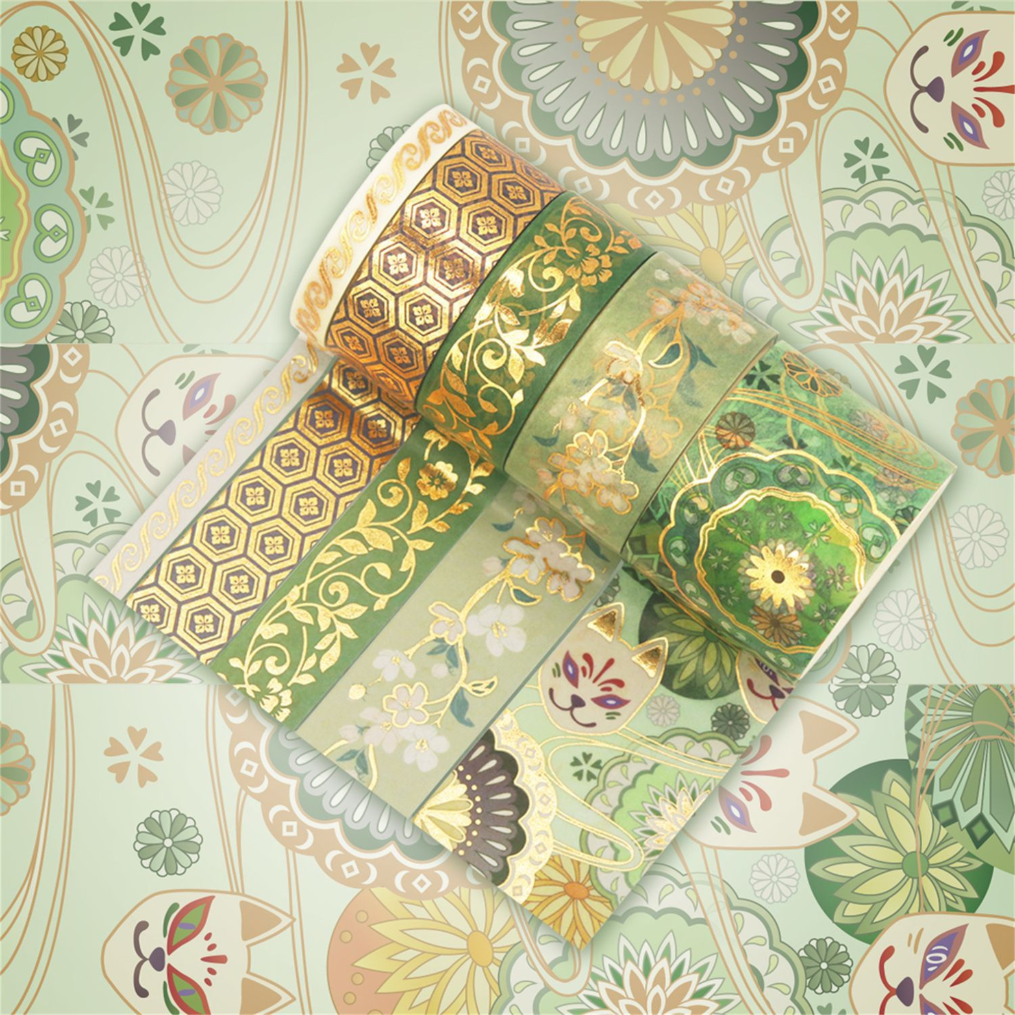 Green and gold brocade washi tape rolls displayed flat, showcasing delicate floral patterns and gold foil accents on a matching patterned background.