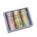 A decorative light blue gift box filled with 15 rolls of brocade gold foil washi tape in various widths and vibrant floral patterns.