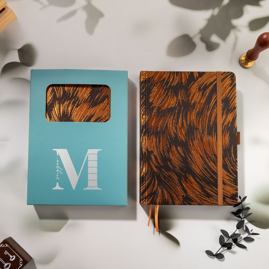 Brown and copper swirl fabric notebook displayed with the signature light blue window-cut gift box and wax seal stamp